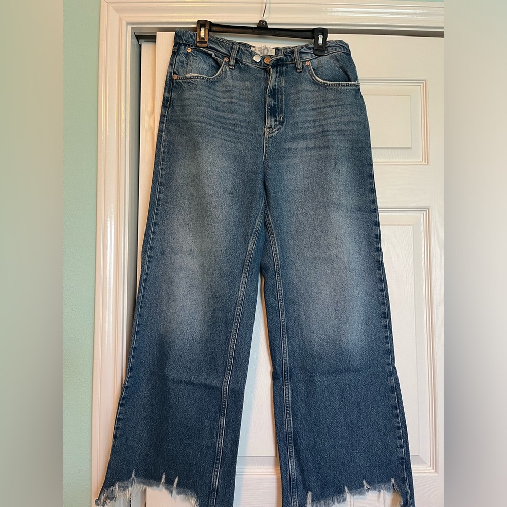 Medium-wash wide leg jeans with distressing